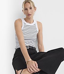 A woman in a striped tank top and black pants sits against a plain white background. carousel Product Image 1