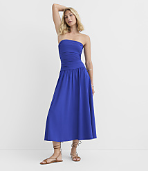 A woman in a blue strapless dress and sandals stands against a plain white background. carousel Product Image 1