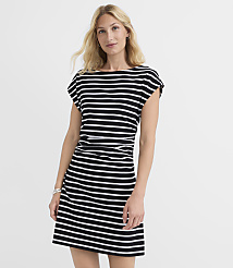 A blonde woman in a black and white striped dress stands against a plain white background. carousel Product Image 1