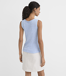A woman in a light blue textured tank top and a cream skirt stands against a plain white background. carousel Product Image 2