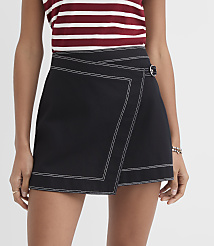 A person in a black wrap skirt with white stitching and a striped top stands against a plain white background. carousel Product Image 2