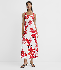 A woman in a white floral dress stands against a plain white background. carousel Product Image 2