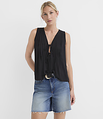 A woman in a black tie-front top and denim shorts stands against a plain white background. carousel Product Image 1