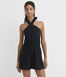 A woman in a black halter romper stands against a plain white background. carousel Product Image 1