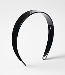 A glossy black headband rests on a plain white background. carousel Product Image 1