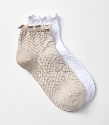 A pair of textured ankle socks, one beige and one white, lie on a plain white background. carousel Product Image 1