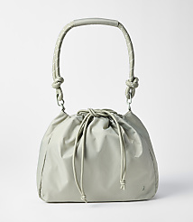 A light gray drawstring bag with a curved handle rests on a plain white background. carousel Product Image 1