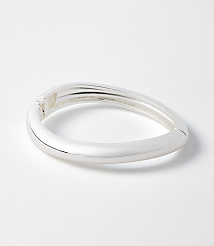 A sleek, silver bangle rests on a plain white background. carousel Product Image 1