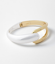 A two-toned bracelet with a silver and gold finish rests on a plain white background. carousel Product Image 1