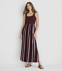 A woman in a burgundy and white striped maxi dress stands against a plain white background. carousel Product Image 1