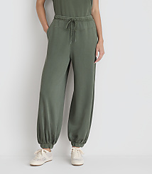 A person wearing olive green sweatpants and sneakers stands against a plain white background. carousel Product Image 2