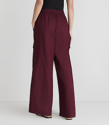 A person stands with their back to the camera, wearing maroon cargo pants and black shoes, against a plain white background. carousel Product Image 3