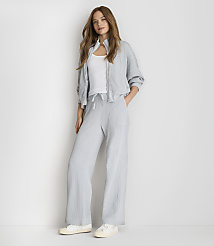 A woman in a light blue tracksuit stands against a plain white background. carousel Product Image 1