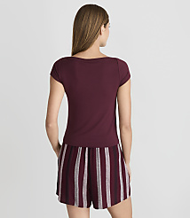 A woman in a maroon t-shirt and striped shorts stands against a plain gray background. carousel Product Image 3