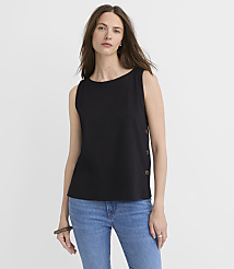 A woman in a black sleeveless top and blue jeans stands against a plain white background. carousel Product Image 1