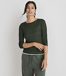 A woman in a green sweater and pants stands against a plain gray background. carousel Product Image 2