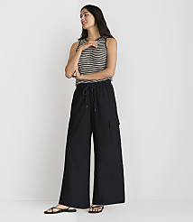 A woman in a striped tank top and black wide-leg pants stands against a plain white background. carousel Product Image 1