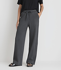 A person in a black t-shirt and gray striped wide-leg pants stands against a plain white background. carousel Product Image 2