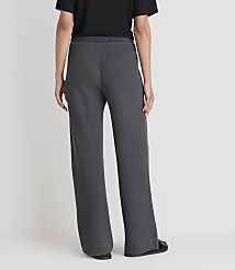 A person wearing dark gray wide-leg pants stands against a plain white background. carousel Product Image 3