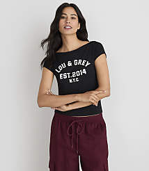 A woman in a black "LOU & GREY EST. 2014 N.Y.C." t-shirt and maroon cargo pants stands against a plain white background. carousel Product Image 1