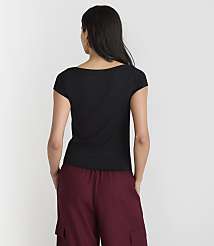 A woman in a black t-shirt and maroon pants stands against a plain white background. carousel Product Image 3
