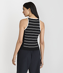 A woman in a black and white striped tank top and dark pants stands against a plain white background. carousel Product Image 3
