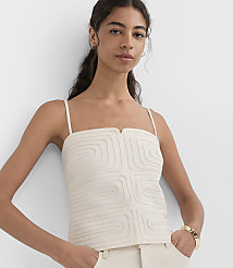 A woman in a cream-colored camisole and pants stands against a plain white background. carousel Product Image 3
