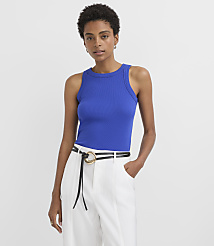 A woman in a blue ribbed tank top and white pinstripe pants stands against a plain white background. carousel Product Image 1