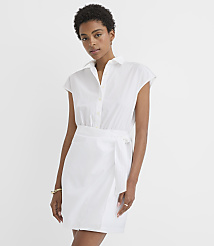 A woman in a white shirt dress with a tie waist stands against a plain white background. carousel Product Image 1