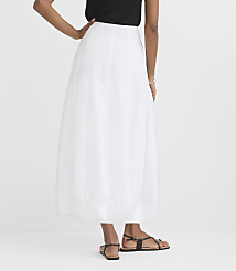 A person in a white skirt and black top stands against a plain white background. carousel Product Image 3