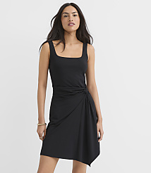 A woman in a black dress stands against a plain white background. carousel Product Image 1