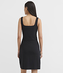 A woman in a black square-neck dress stands against a plain white background. carousel Product Image 2