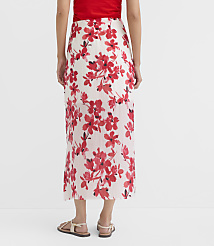 A person wearing a white skirt with red floral print stands on a plain white background. carousel Product Image 3