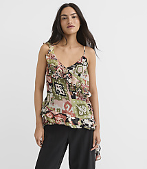 A woman in a patterned camisole and black pants stands against a plain white background. carousel Product Image 1