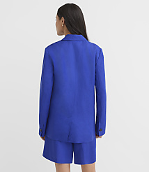 A woman in a blue blazer and shorts stands against a plain white background. carousel Product Image 3