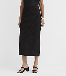 A person wearing a black ribbed midi skirt and black block-heeled sandals stands against a plain white background. carousel Product Image 2