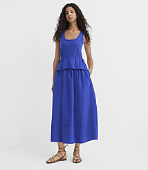 A woman in a blue tiered dress and sandals stands against a plain white background. carousel Product Image 1