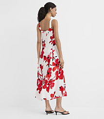 A woman in a white floral dress stands against a plain white background. carousel Product Image 3