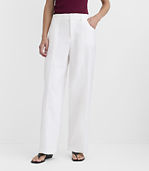 A person stands in white wide-leg pants and a maroon top against a plain white background. carousel Product Image 3