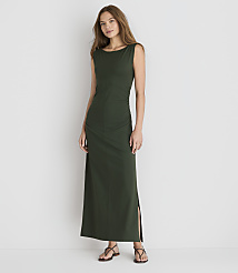 A woman in a dark green maxi dress stands against a plain white background. carousel Product Image 1