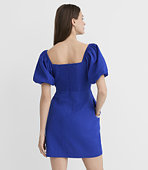 A woman in a blue puff-sleeve dress stands against a plain white background. carousel Product Image 2