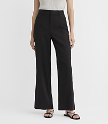 A person stands in black wide-leg pants and sandals against a plain white background. carousel Product Image 3