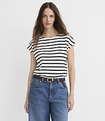 A woman in a striped shirt and jeans stands against a plain white background. carousel Product Image 1