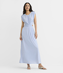 A woman in a light blue maxi dress with cutouts stands against a plain white background. carousel Product Image 4