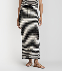 A person stands wearing a black and white striped maxi skirt and sandals against a plain white background. carousel Product Image 2