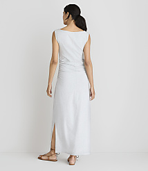 A woman in a light gray maxi dress with ruched detailing and a side slit stands with her back to the camera against a plain white background. carousel Product Image 3