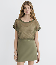 A woman in a sheer olive green top and olive green skirt stands against a plain white background. carousel Product Image 1