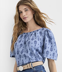 A woman with long blonde hair wears a blue patterned off-the-shoulder top and a beige belt against a plain white background. carousel Product Image 1
