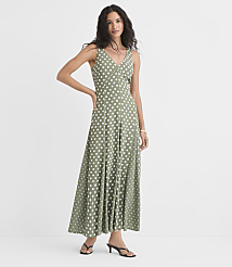 A woman in a polka-dot maxi dress stands against a plain white background. carousel Product Image 2