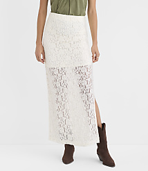 A woman in a white lace maxi skirt and brown boots stands against a plain white background. carousel Product Image 2